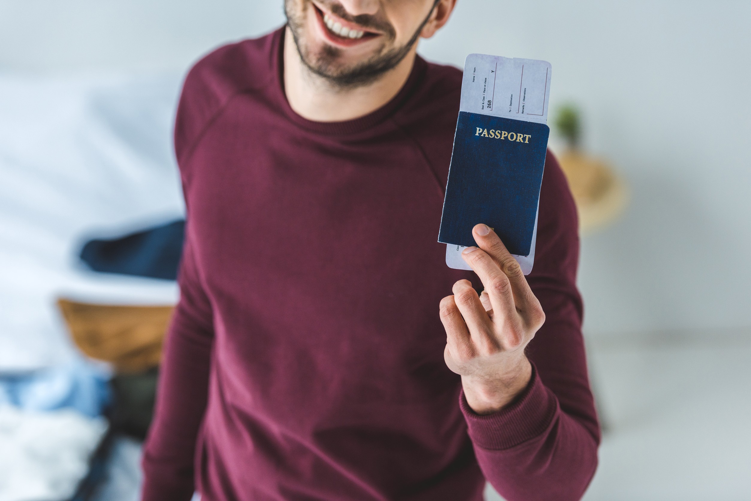 Cropped View Of Smiling Man Holding Passport And Air Ticket